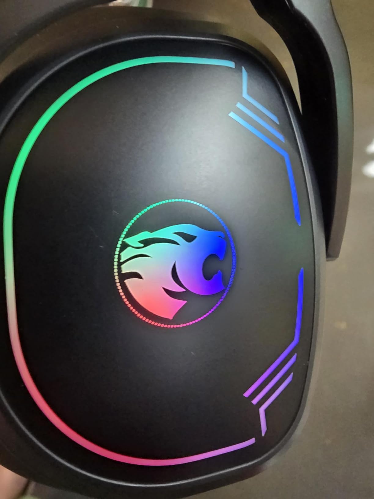 Close-up of the IMYB A36 earcup with the RGB outline lit around the panther head logo